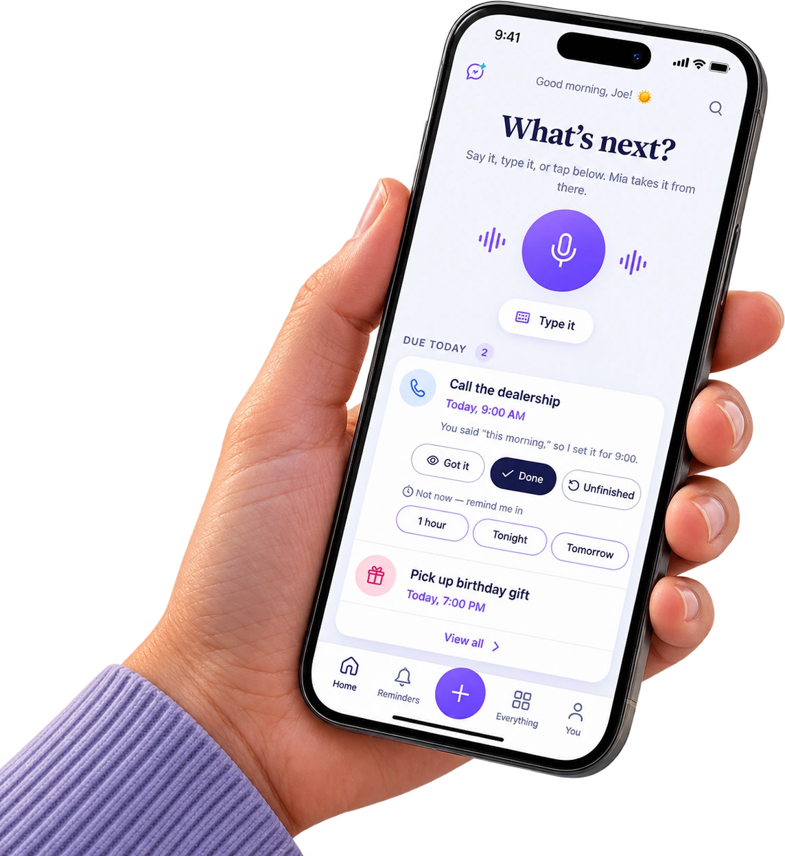 Mia on a phone held in one hand — the What's next screen with today's reminders
